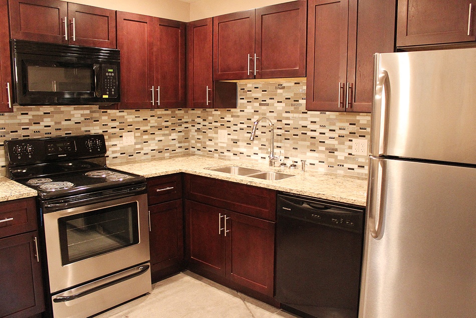 a kitchen with wooden cabinets and stainless steel appliances